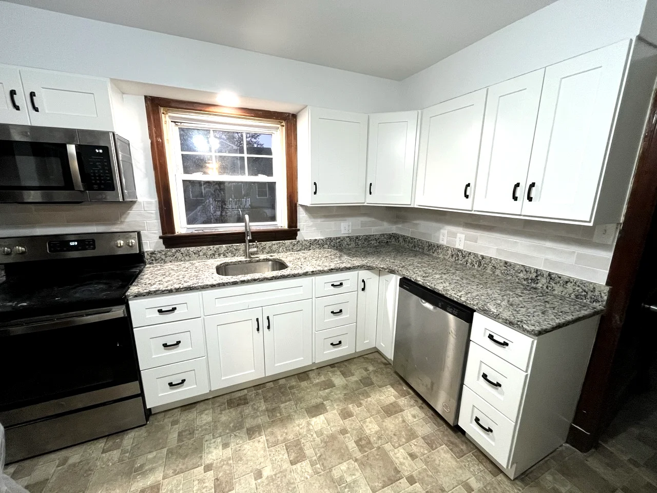 Renovated kitchen with new cabinets, countertops, and updated finishes